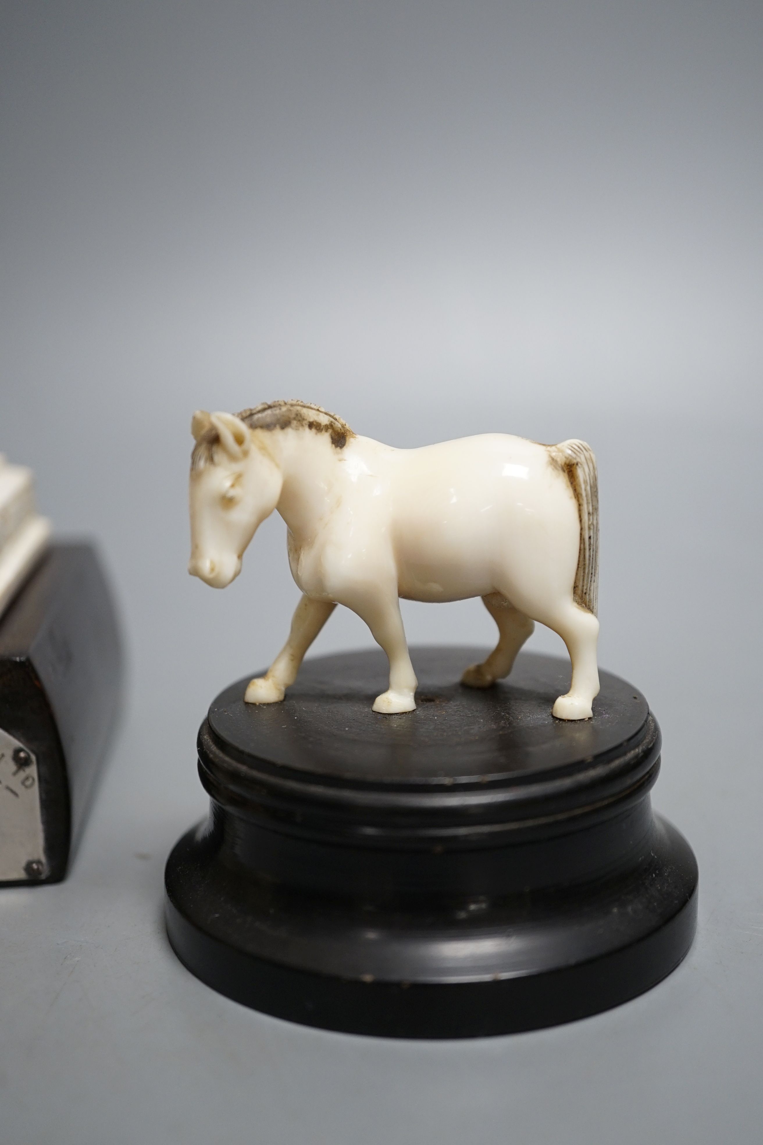 An Indian ivory sedan chair, an ivory horse and an ivory man on camel (General Gordon) with white metal plaque, 19th/early 20th century , Ivory carving of a man on a camel 14.5cms high.